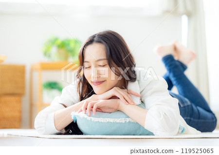 微笑的年輕女子躺在客廳裡 119525065