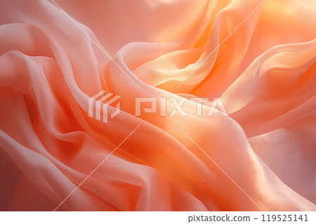 Close-up photo of delicate peach-colored fabric with a soft, flowing texture 119525141