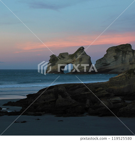 Rock formation at sunset, Wharariki Beach, New Zealand. 119525580