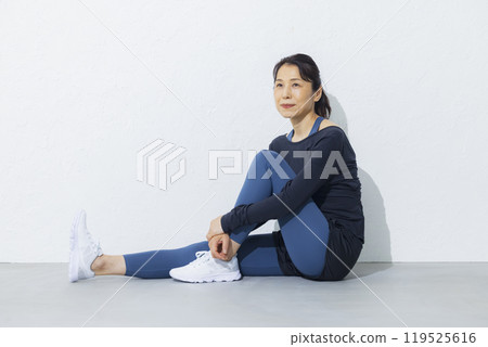 A woman in her 50s stretching 119525616