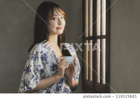 A woman by the window 119525683