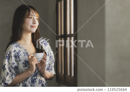 A woman by the window 119525684