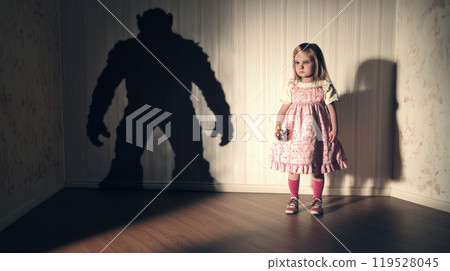 This striking image portrays a little girl clutching her doll, standing in front of a massive, ominous shadow shaped like a monstrous figure, much larger than her. Generative AI This striking image portrays a little girl clutching her doll, standing in front of a massive, ominous shadow shaped like a monstrous figure, much larger than her. Generative AI 119528045