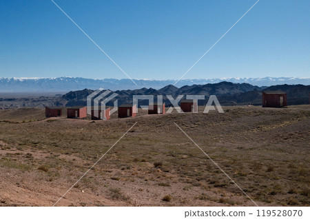 Isolated desert lodging: Modern wooden structures on hillside with panoramic views 119528070