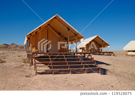 Luxury desert glamping. Upscale tent lodge with wooden deck Luxury desert glamping. Upscale tent lodge with wooden deck 119528075