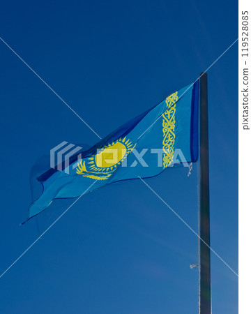 Kazakhstan flag waving against clear blue sky 119528085