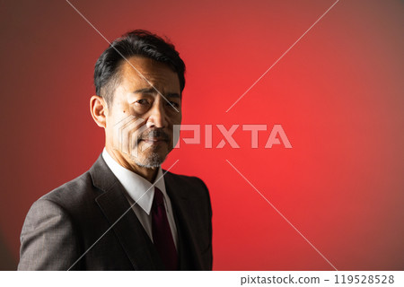 A man in his 50s looking at the camera portrait 119528528