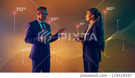 Business leader, with assistant presents key data trends with colorful bar graphs during formal meeting. Business leader, with assistant presents key data trends with colorful bar graphs during formal meeting. 119528587