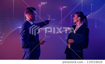 Corporate speaker with his assistant analyzes financial data trends using interactive chart as focal point. 119528626