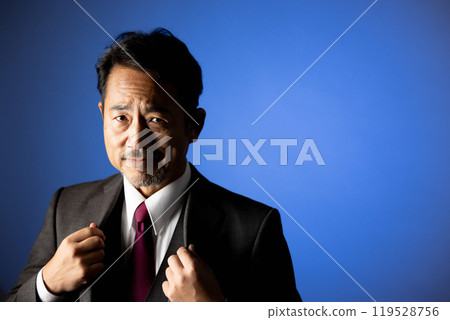 A man in his 50s looking at the camera portrait A man in his 50s looking at the camera portrait 119528756