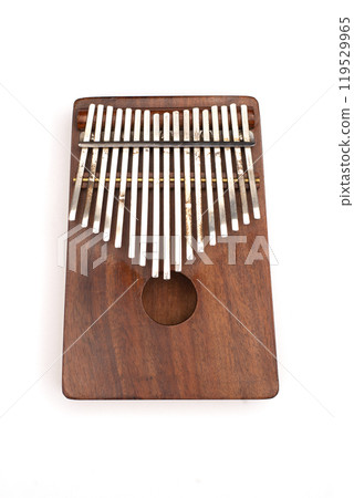 Kalimba or mbira is an African musical instrument. Kalimba made from wooden board with metal isolated on white background 119529965
