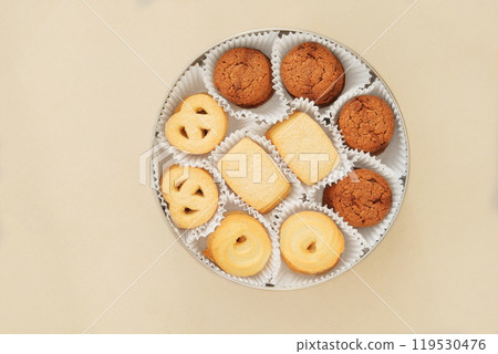 Cookies set in a metal box. Sweet dessert for holiday on beige background. Variety of biscuit. Top view. Cookies set in a metal box. Sweet dessert for holiday on beige background. Variety of biscuit. Top view. 119530476
