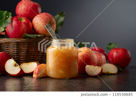 Apple jam and fresh apples on a black stone table. 119530685