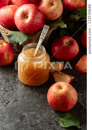 Apple jam and fresh apples on a black stone table. 119530686