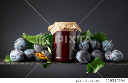Plum jam and fresh berries on a black background. 119530694