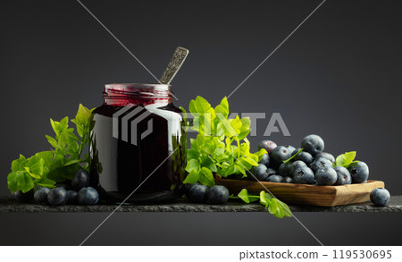 Blueberry jam and fresh berries with leaves. 119530695