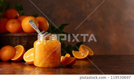 Orange jam and fresh fruits on a brown vintage table. 119530697