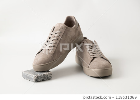 Leather nubuck gray men's gumshoes on light gray background. Close up. Men's sports casual shoes. Fashionable sneakers. Leather nubuck gray men's gumshoes on light gray background. Close up. Men's sports casual shoes. Fashionable sneakers. 119531069