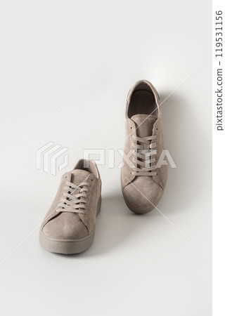 New classic sports men's gray nubuck leather sneakers for cold season on gray background. Special care. Sale concept. 119531156