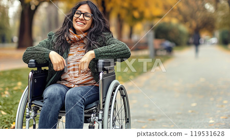Joyful autumn day: smiling disabled woman in a wheelchair enjoys park outing Joyful autumn day: smiling disabled woman in a wheelchair enjoys park outing 119531628