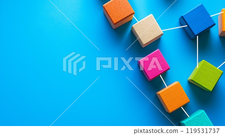 Colorful wooden cubes connected by strings on blue background for conceptual design Colorful wooden cubes connected by strings on blue background for conceptual design 119531737
