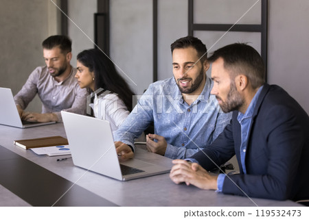 Positive multiethnic business men watching online presentation on laptop Positive multiethnic business men watching online presentation on laptop 119532473