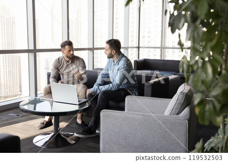 Two young entrepreneurs men meeting in co-working space Two young entrepreneurs men meeting in co-working space 119532503