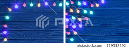 christmas garland lights on blue wooden background with copy space for your text. Top view 119532892