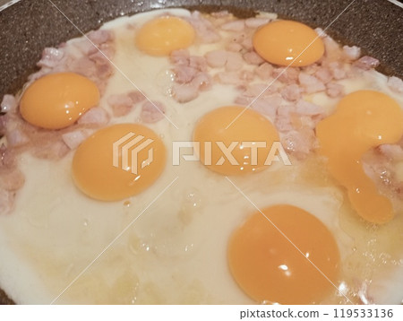 fried eggs with ham in a frying pan 119533136