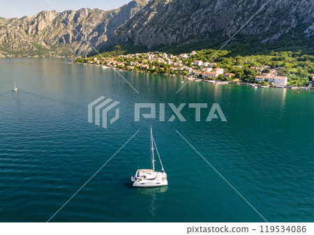 Yacht catamaran at anchor near the shore. Concept of active and luxurious rest Yacht catamaran at anchor near the shore. Concept of active and luxurious rest 119534086