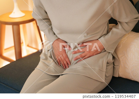 Middle-aged woman with stomach ache at night 119534407
