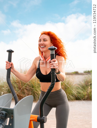 Cheerful woman exercising on stepper machine at Cheerful woman exercising on stepper machine at 119534712