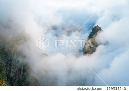 A mountain covered in fog and clouds. Madeira island, Portugal A mountain covered in fog and clouds. Madeira island, Portugal 119535240