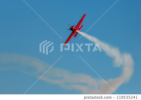 Stunt aerobatic plane performing stunts in air Stunt aerobatic plane performing stunts in air 119535241
