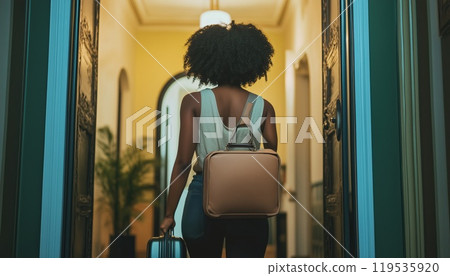 African American Woman Entering Hotel Room With Suitcase In Hand, Back View, Cropped Image With Space For Text. African American Woman Entering Hotel Room With Suitcase In Hand, Back View, Cropped Image With Space For Text. 119535920
