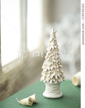 Old books and Christmas accessories placed on an antique windowsill 119536183