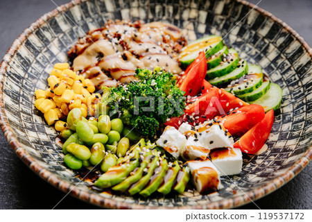Colorful Buddha bowl with fresh vegetables, quinoa, and avocado, healthy eating and wellness lovers 119537172