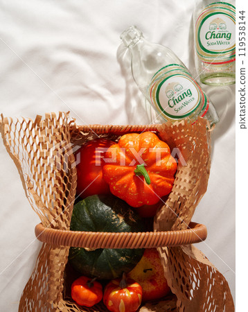 Still life of colorful pumpkins and fruits in harvest atmosphere basket 119538144