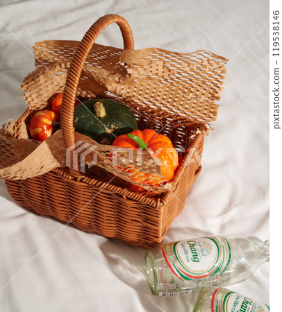 Autumn harvest still life with pumpkins and fruits in basket 119538146