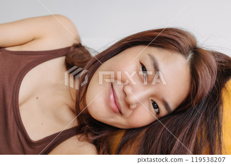 Close up of happy woman selfie herself enjoy relaxing on the sofa and pillow. Close up of happy woman selfie herself enjoy relaxing on the sofa and pillow. 119538207