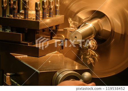 The lathe machine finish cut the metal shaft parts. 119538452