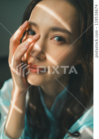 Young woman with rays of light Young woman with rays of light 119538674