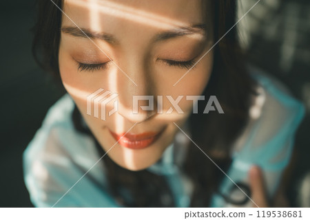 Young woman with rays of light Young woman with rays of light 119538681