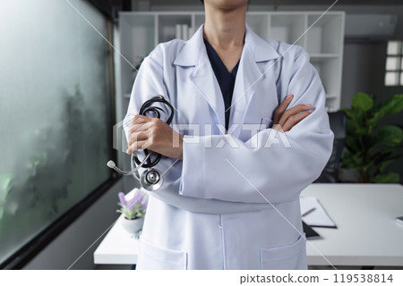 Confident Female Doctor in White Coat with Stethoscope in Modern Medical Office Setting 119538814