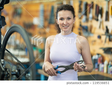 Adult woman posing with bicycle tool 119538851