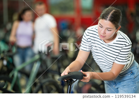 Young woman choosing bike in store 119539134