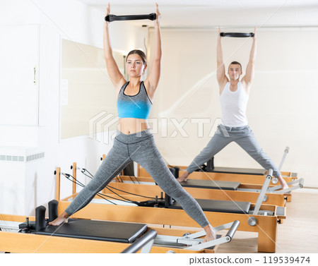 Girl restores her health with the help of gymnastic ring during Pilates classes 119539474
