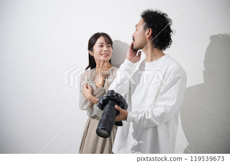 Photographer teaching model how to pose Photographer teaching model how to pose 119539673