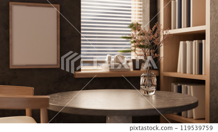 A round dark stone marble table by the window and a bookshelf in a cozy contemporary room. 119539759
