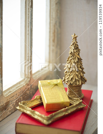 Christmas tree and presents placed on a retro window sill 119539934